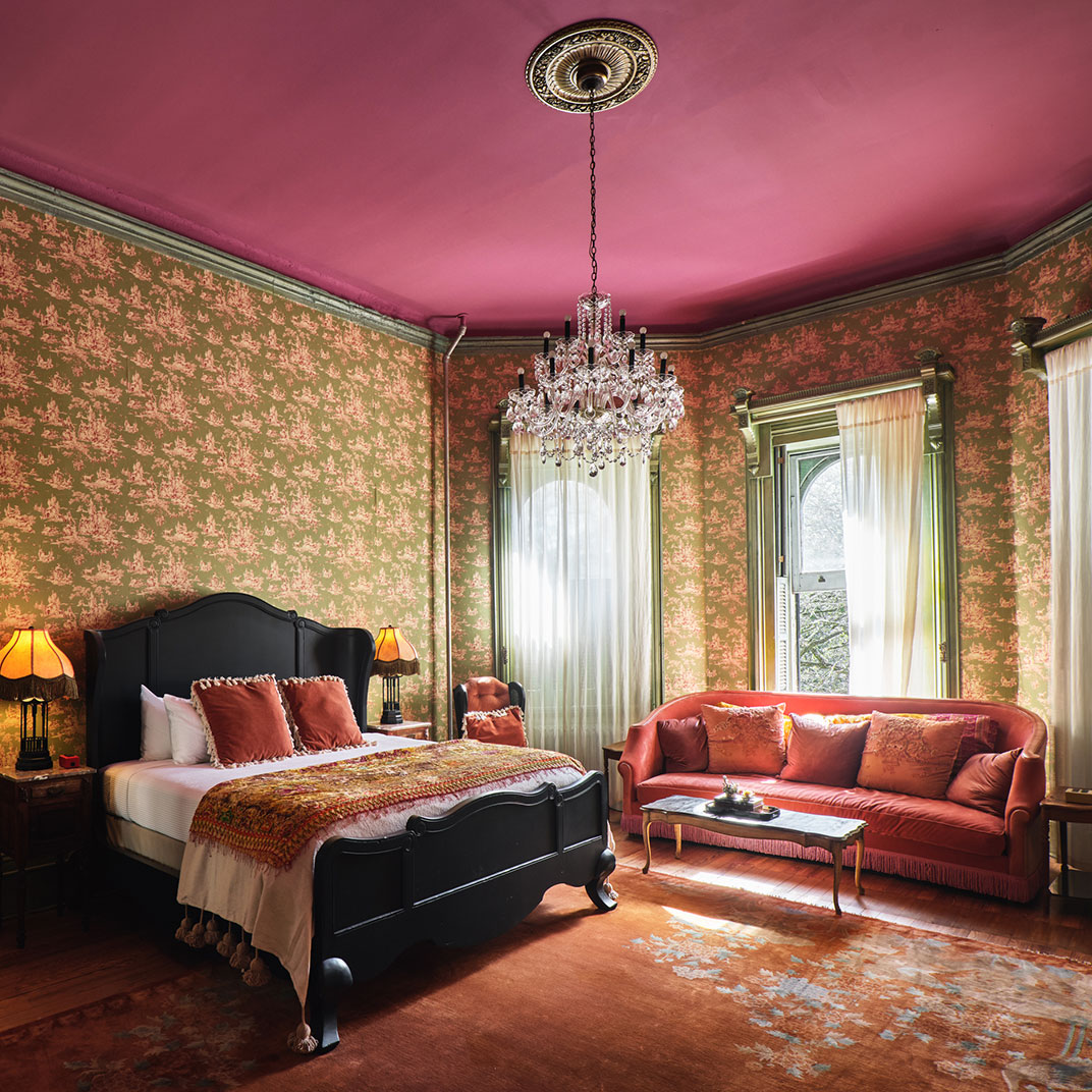 Lush and moody rooms in the historic building at Columns. ©Columns