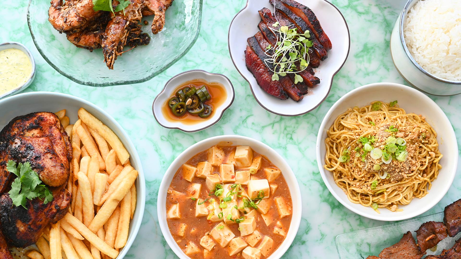 Various dishes at Chifa, including pollo a la brasa and mapo tofu. ©Chifa