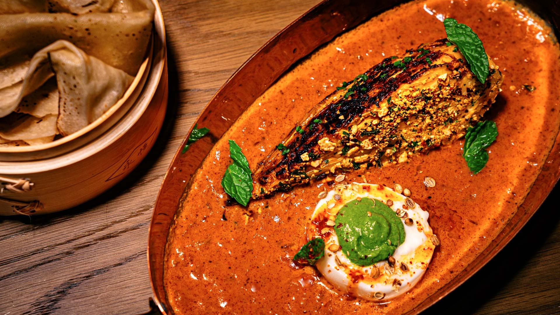 Hispi cabbage with tikka masala, burrata cheese, and green chutney. ©Eylan